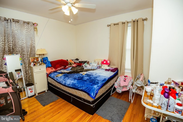 bedroom with hardwood / wood-style flooring and ceiling fan