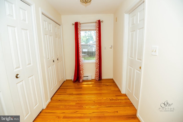 hall featuring baseboard heating and light wood-type flooring