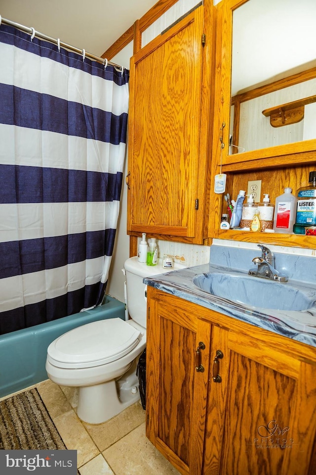 full bathroom featuring tile patterned flooring, vanity, toilet, and shower / bathtub combination with curtain