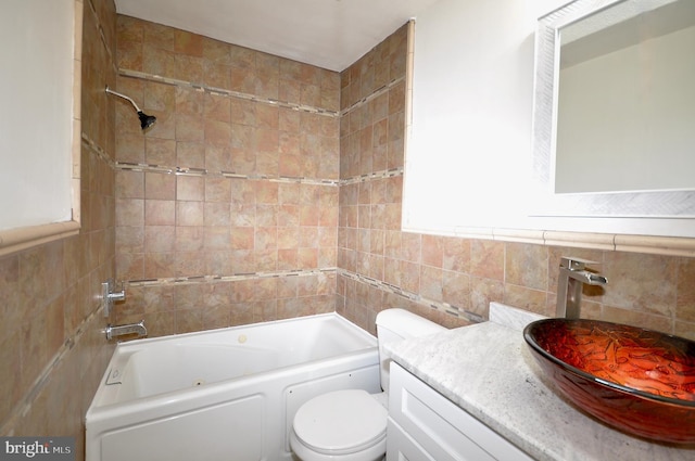 full bathroom featuring vanity, toilet, and tiled shower / bath