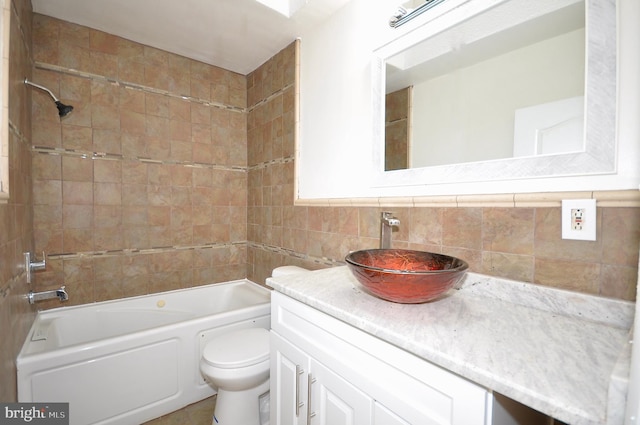 full bathroom featuring vanity, backsplash, toilet, and tiled shower / bath combo