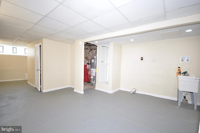 basement featuring a paneled ceiling and gas water heater