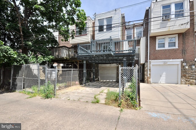 townhome / multi-family property featuring a garage and a deck