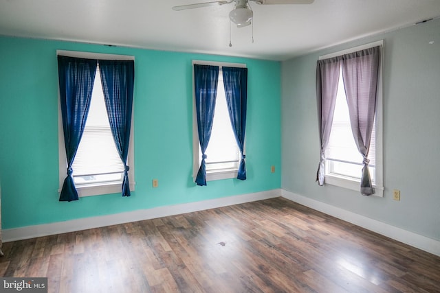 unfurnished room featuring ceiling fan, a healthy amount of sunlight, and wood-type flooring