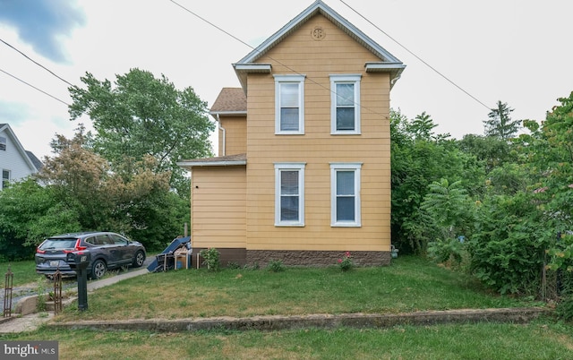 view of home's exterior featuring a lawn