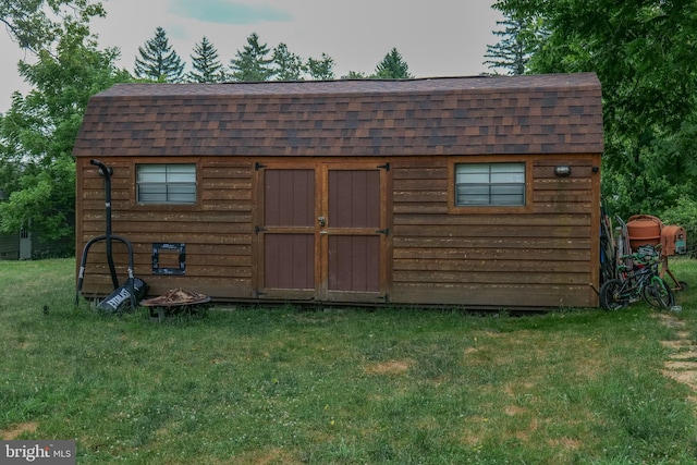 view of outdoor structure featuring a lawn