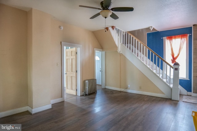 unfurnished living room featuring a textured ceiling, dark hardwood / wood-style floors, radiator, and ceiling fan