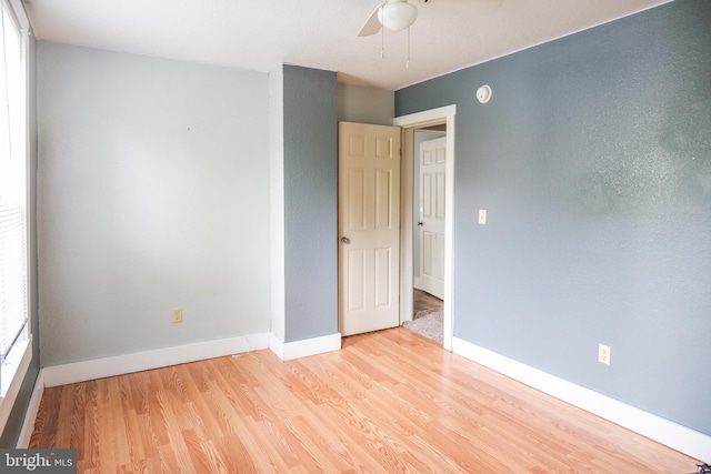 empty room featuring ceiling fan and light hardwood / wood-style flooring