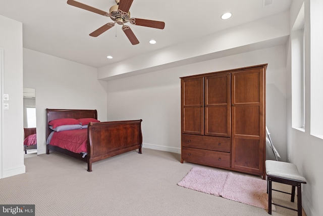 bedroom with ceiling fan and light carpet