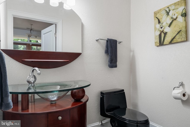 bathroom featuring vanity and toilet