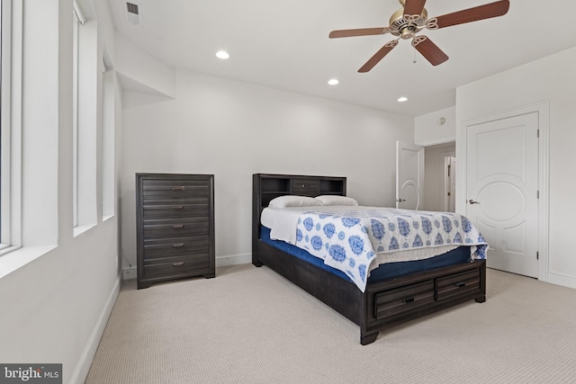 bedroom featuring ceiling fan and light carpet