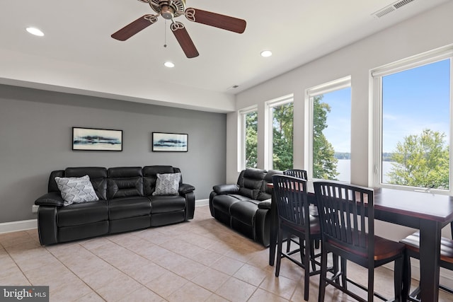 tiled living room featuring ceiling fan