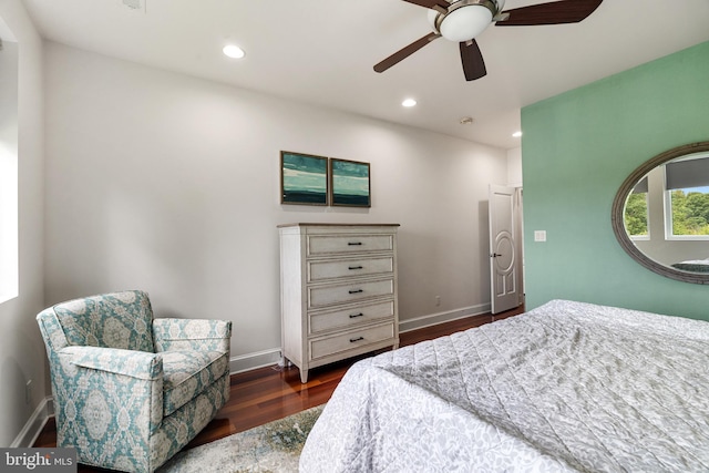 bedroom with dark hardwood / wood-style flooring and ceiling fan