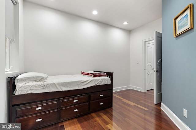 bedroom featuring dark hardwood / wood-style flooring