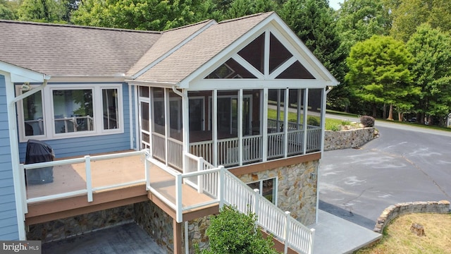 back of house featuring a patio area and a sunroom