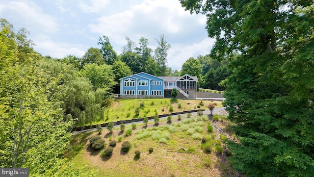 rear view of property with a sunroom