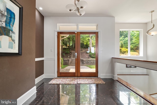 doorway with an inviting chandelier and french doors