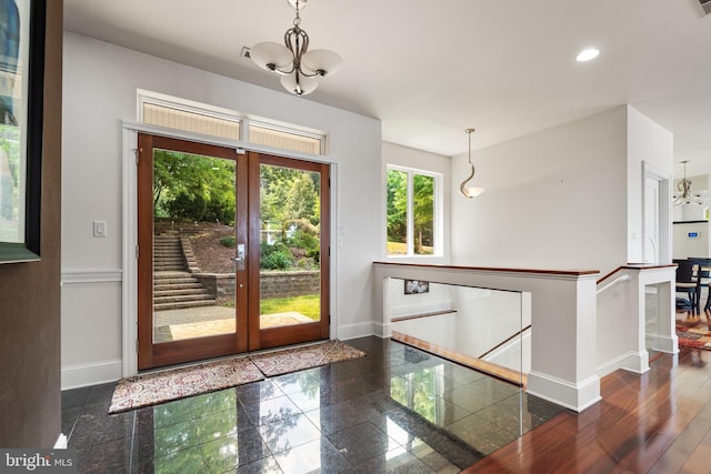 doorway to outside with french doors and an inviting chandelier