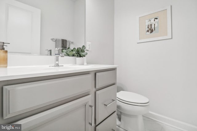 bathroom with tile patterned flooring, vanity, and toilet