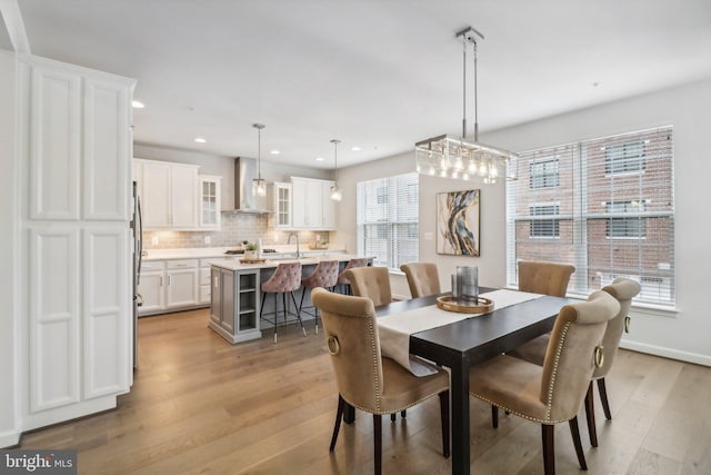 dining room featuring light hardwood / wood-style flooring and sink