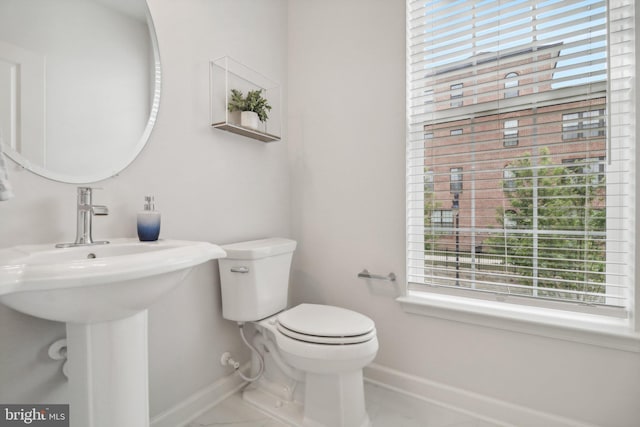 bathroom featuring tile patterned flooring and toilet