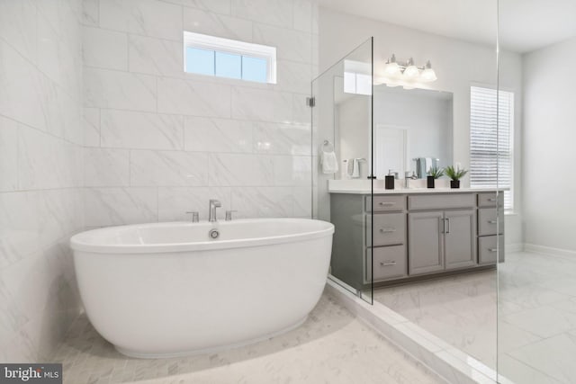 bathroom with plus walk in shower, vanity, and tile walls