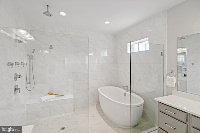 bathroom with vanity, tile walls, and independent shower and bath