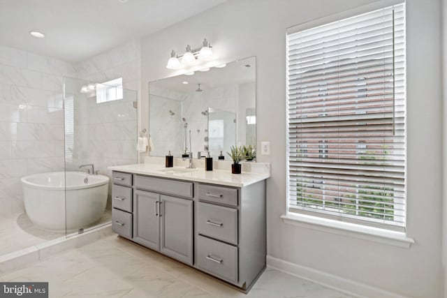 bathroom with vanity and shower with separate bathtub