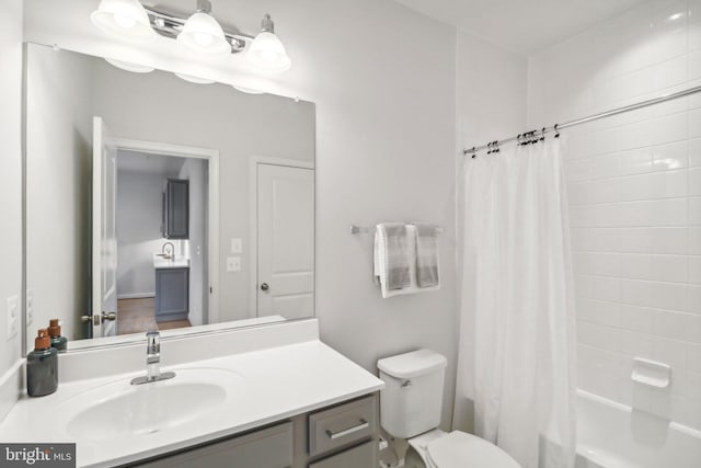 full bathroom featuring vanity, toilet, and shower / bath combo with shower curtain