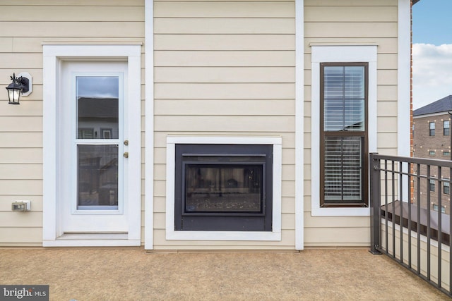 doorway to property featuring exterior fireplace