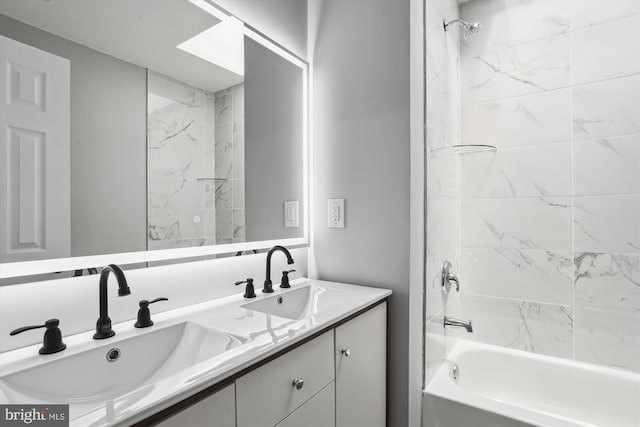 bathroom featuring vanity and tiled shower / bath