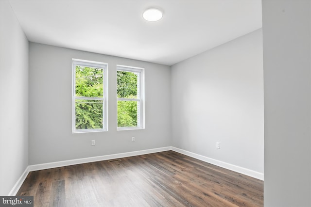 spare room featuring dark hardwood / wood-style floors