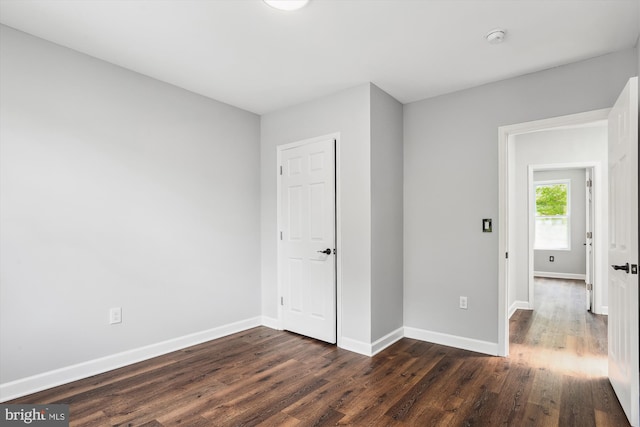 unfurnished bedroom featuring dark hardwood / wood-style flooring