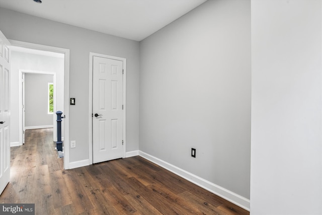 spare room with dark wood-type flooring