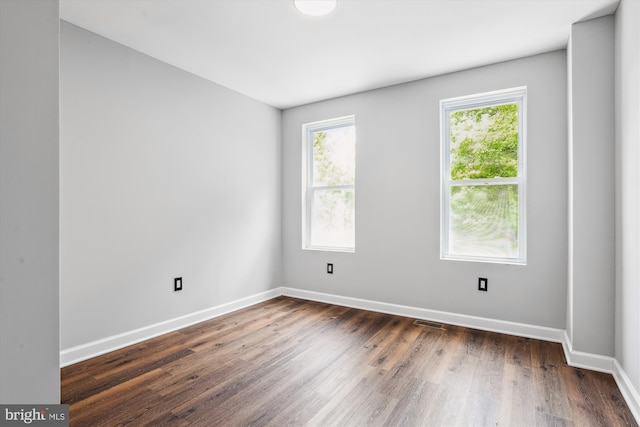 spare room with dark hardwood / wood-style floors