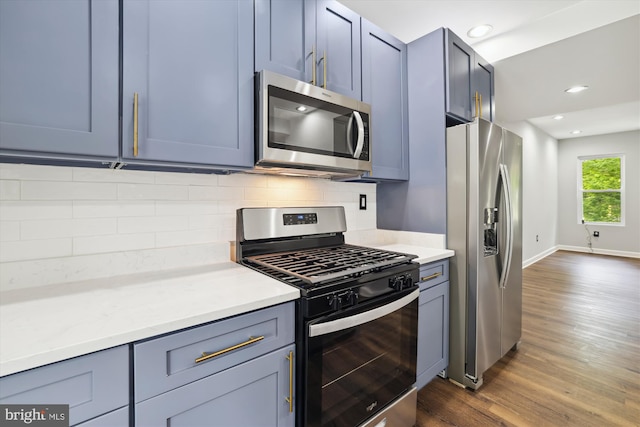 kitchen with backsplash, dark hardwood / wood-style flooring, and stainless steel appliances