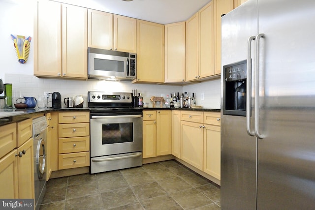 kitchen with washer / clothes dryer, appliances with stainless steel finishes, light brown cabinets, and tasteful backsplash