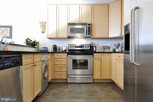 kitchen with light brown cabinetry, stainless steel appliances, decorative backsplash, and washer / clothes dryer