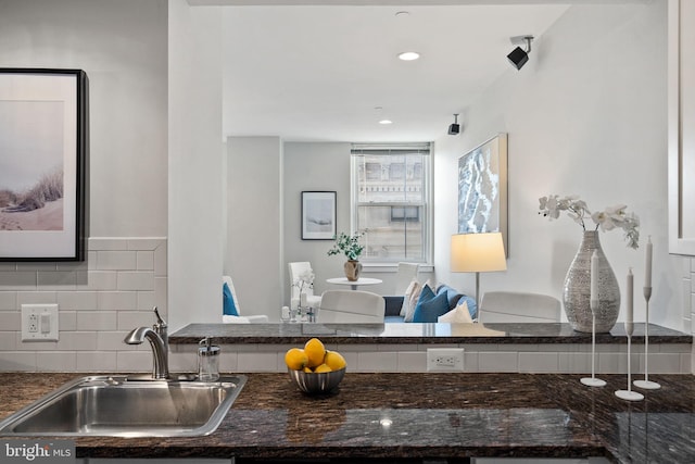 kitchen featuring tasteful backsplash and sink