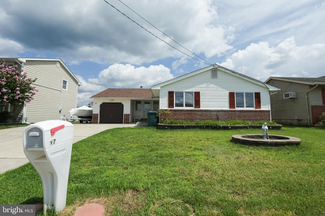 view of front of house with a garage, a front yard, brick siding, and driveway