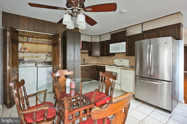 kitchen featuring a sink, white appliances, independent washer and dryer, and light tile patterned floors