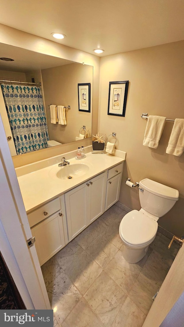 bathroom featuring vanity and toilet