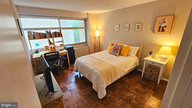 bedroom featuring dark parquet flooring