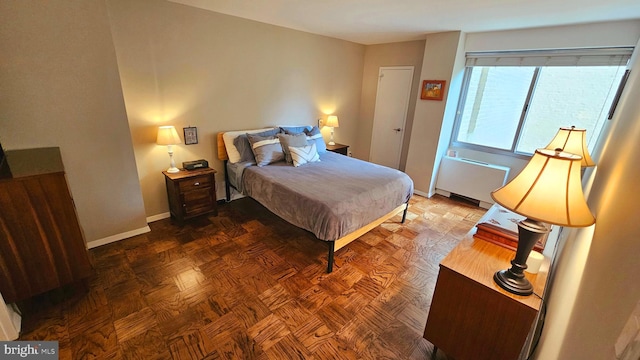 bedroom featuring dark parquet flooring and radiator