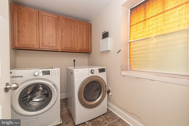 washroom with cabinets and washing machine and dryer