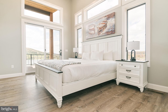 bedroom with dark hardwood / wood-style flooring and access to exterior