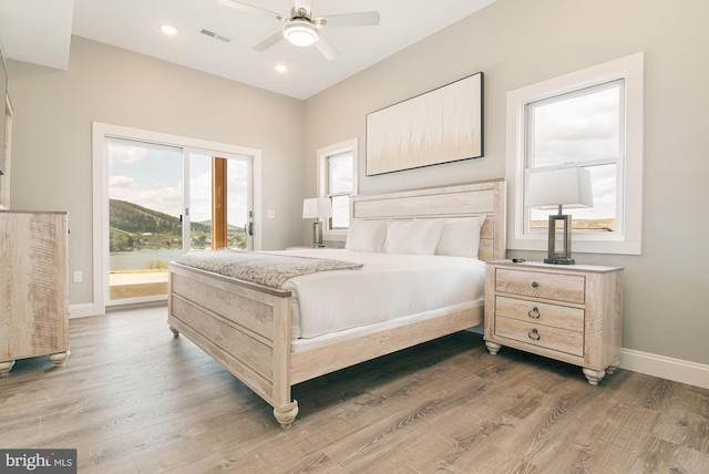 bedroom featuring ceiling fan, wood-type flooring, and access to outside