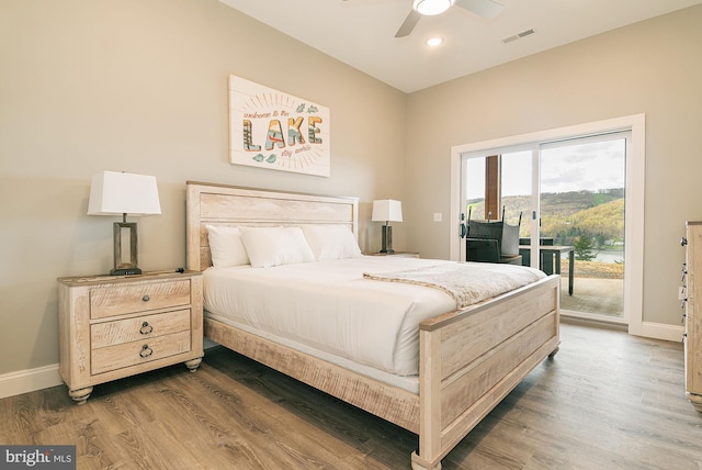 bedroom with dark hardwood / wood-style flooring, access to outside, and ceiling fan