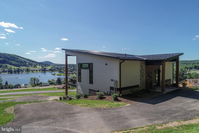 rear view of property with a water and mountain view