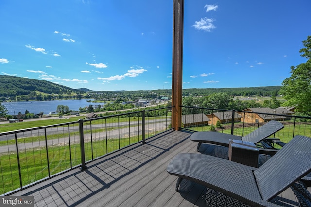 wooden terrace with a water and mountain view